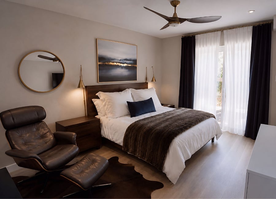 Luxury king bedroom with plush bed, hotel-quality linens, smart TV, dimmable designer lighting, and private balcony access