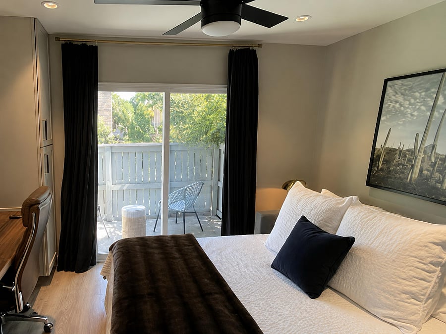 Quiet second bedroom with premium linens, blackout curtains, Smart TV, and private balcony access - perfect for morning coffee or wine nights