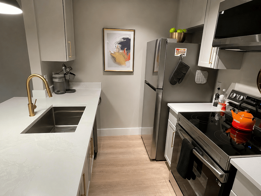 Chefs kitchen with Calacatta quartz countertops, stainless appliances & coffee station