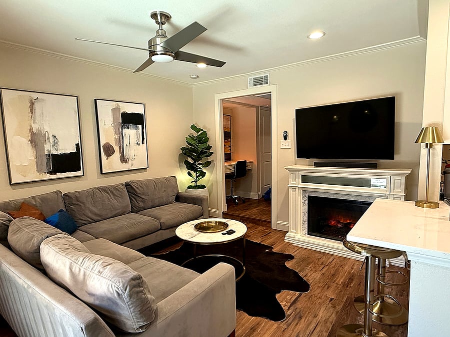Modern living room with 65-inch Smart TV, electric fireplace & full work-from-home setup