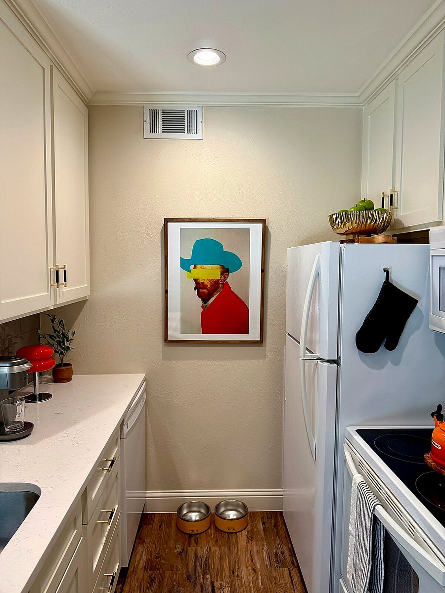 Fully equipped kitchen with pantry, spice rack, cooking essentials, coffee bar, and counter-height seating overlooking the living area