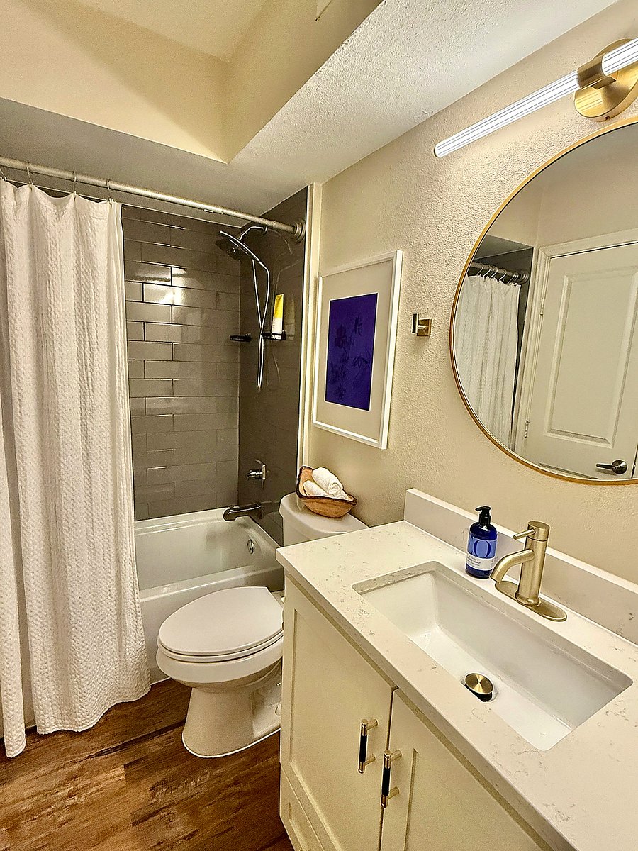 Spa-style bathroom with full-size soaking tub, rain shower, and hotel-quality finishes, fresh towels & essentials included.
