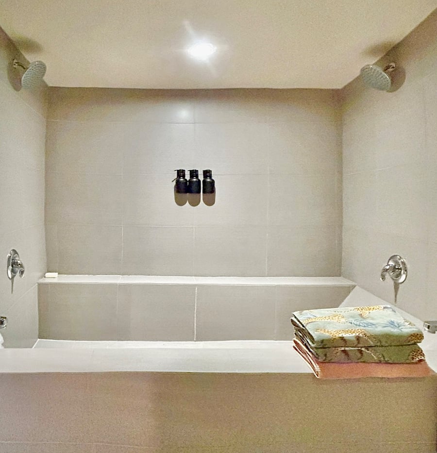 Large two headed shower and bathtub.