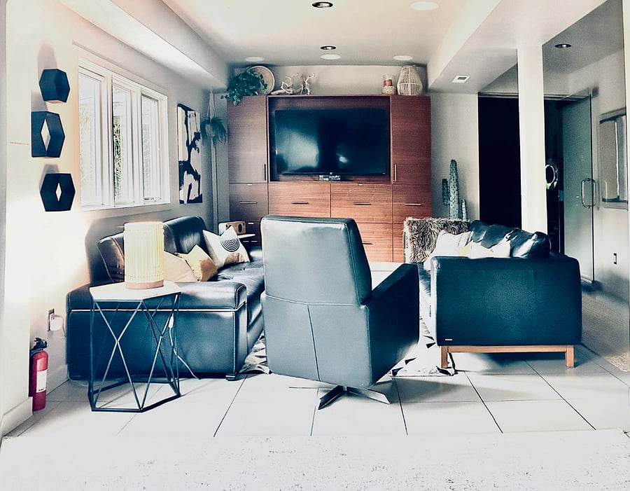 Living room with 2 large cozy sofas, swivel chair, Roku streaming TV & amazing natural light.