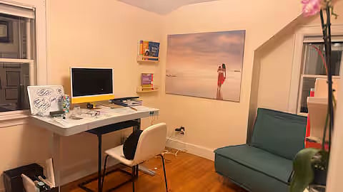 Office upstairs with standing desk and couch that unfolds to single mattress
