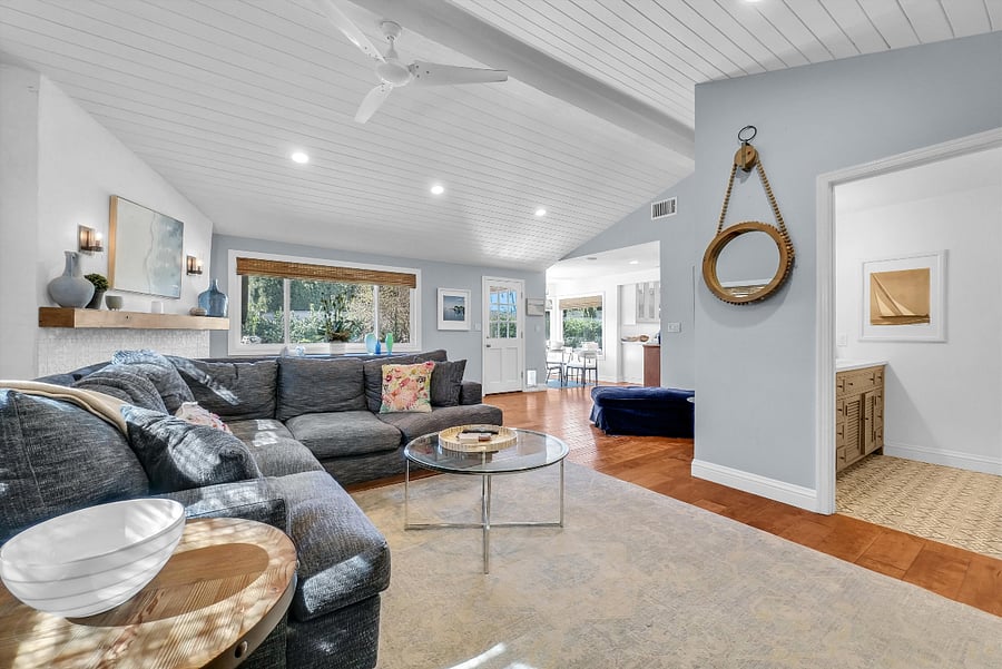 Relaxed family room with tv and separate access to the backyard.