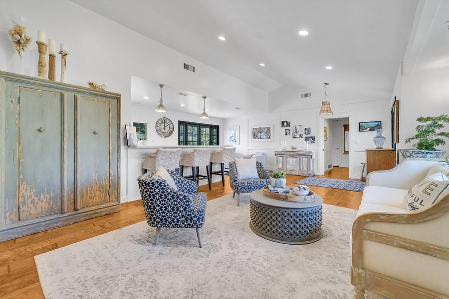 Hardwood floors and open access to backyard and kitchen with bar stools for easy hang out space.