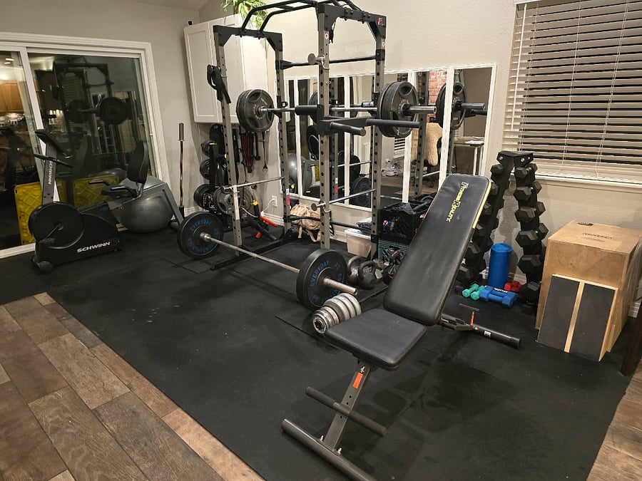 Gym area with weights, rack, dip bar, stationary bike, etc.