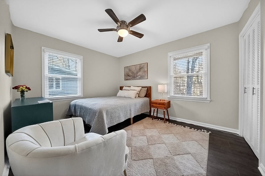 Bedroom with Queen bed and ceiling fan.
