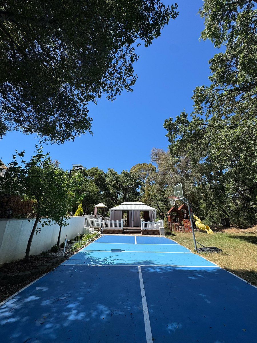 Backyard pickleball court, basketball and deck for BBQ with chairs and tables