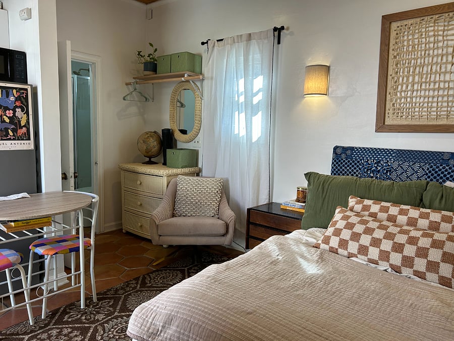 Full-size bed with breakfast area and closet.