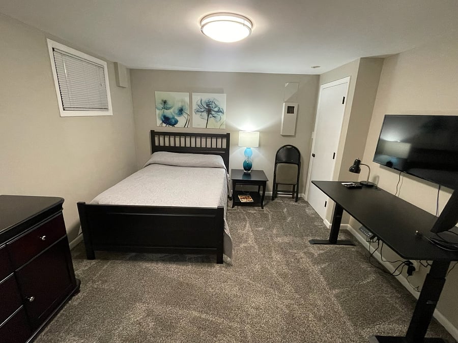 Lower Bedroom #3 with smart screen wall mounted TV
