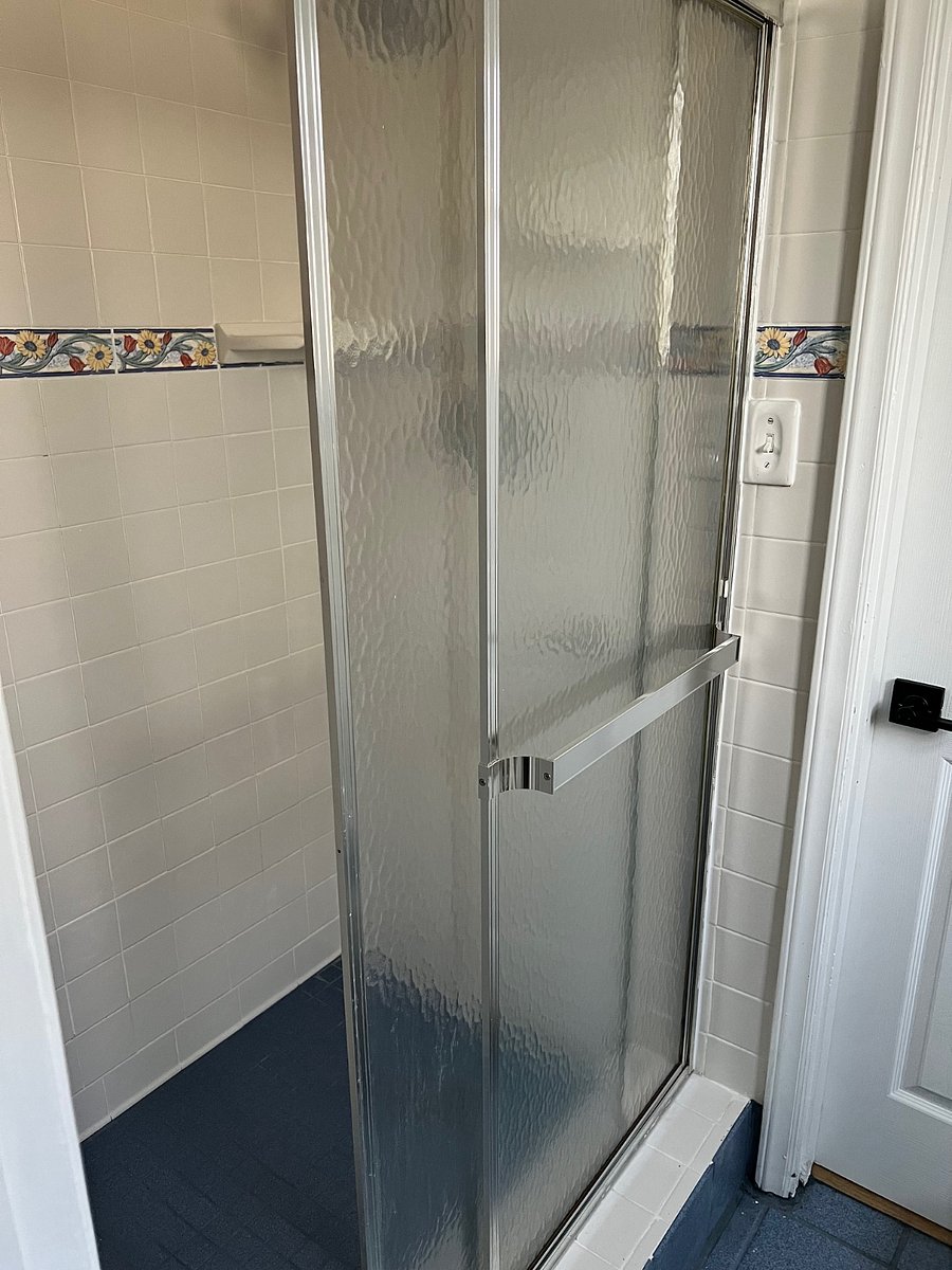 Bathroom with walk-in shower, sink and toilet.