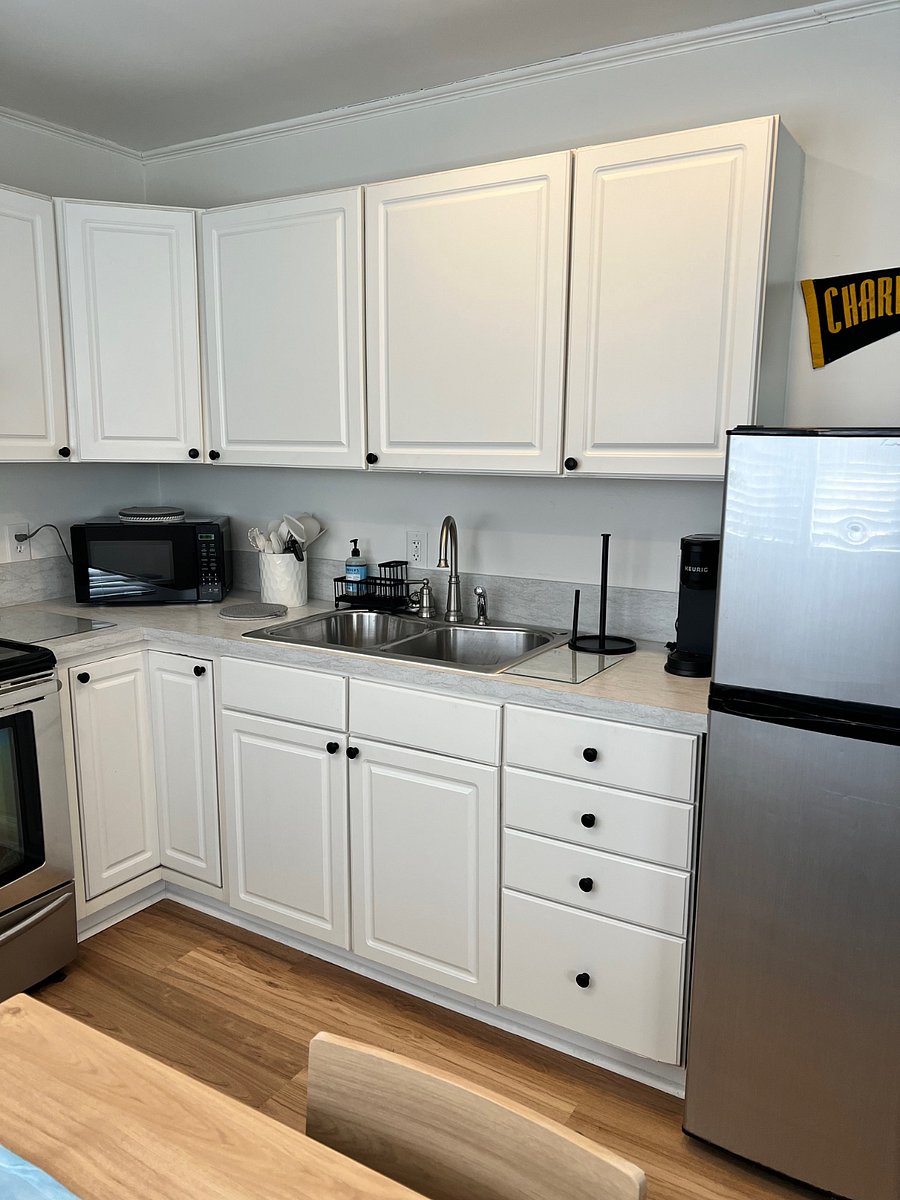 Kitchen includes numerous coffee makers with cups, plates, silverware, bowls, etc.