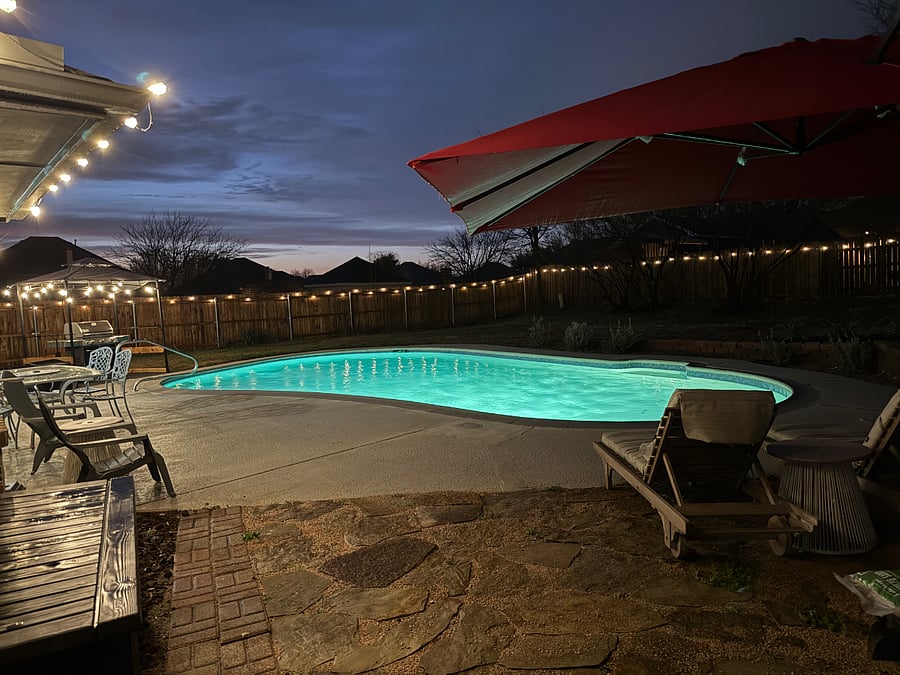 Pool at night from the lounger chairs and 10 foot umbrellas