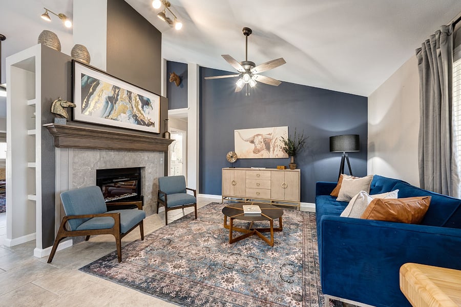 Front Living Room: Features velvet queen sleeper sofa (sleeps 2), mid century seating and an electric fireplace for ambiance.