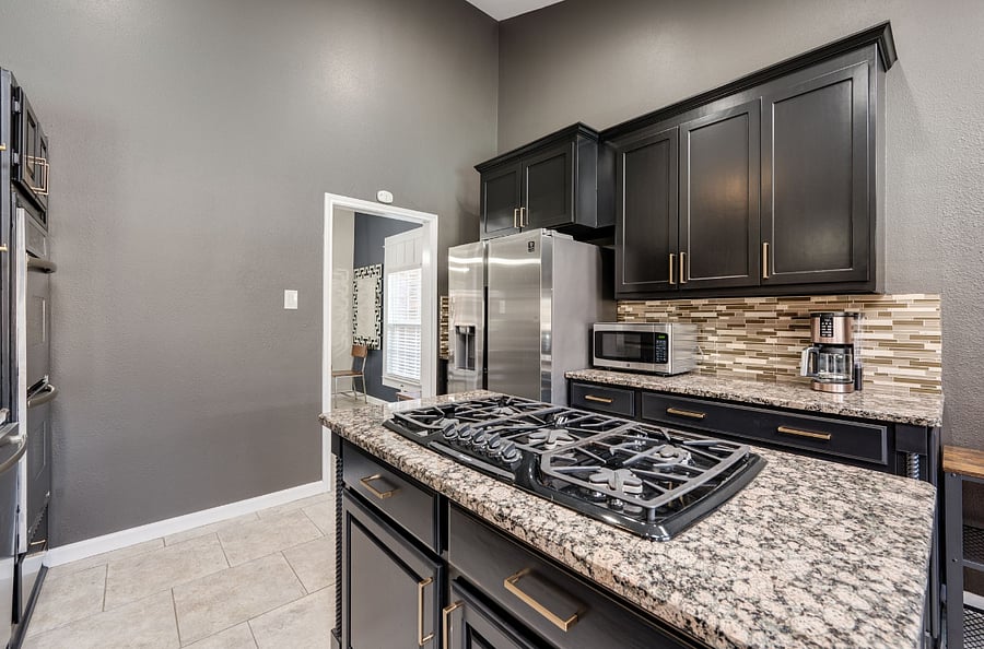 The large kitchen features vaulted ceilings and skylights. Fully stocked with Daily dishes, pool dishes, etc