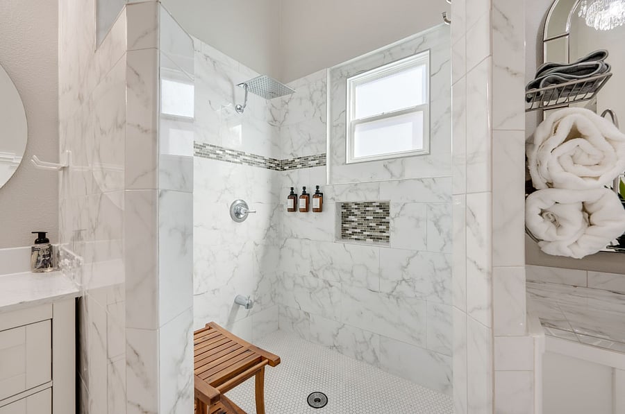 Walk in shower with rain head showerhead. Teak stool