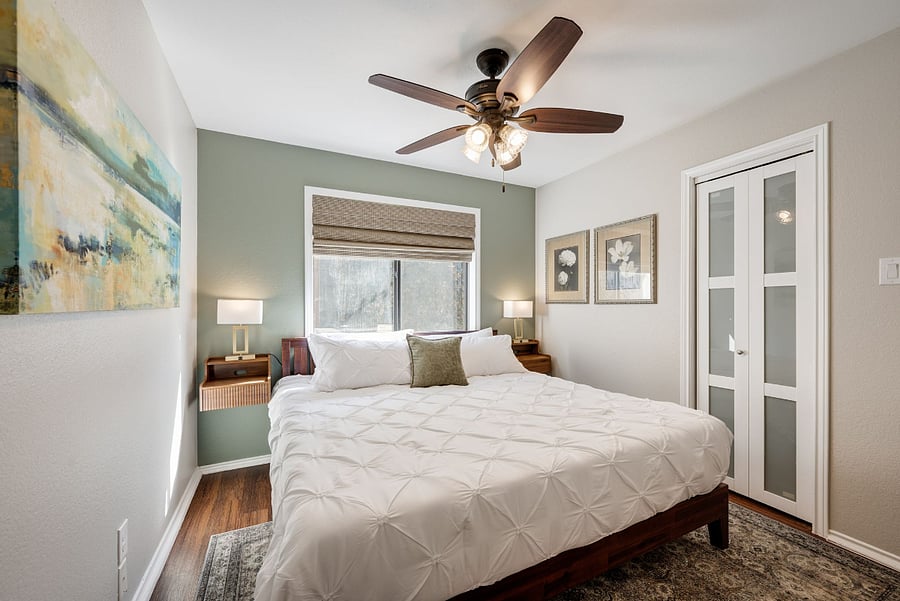 Bedroom 2: The Sage Room. Beautifully decorated and lots of light . Features a King Size bed and walk in closet with Sherwin Williams Evergreen Fog paint accent wall