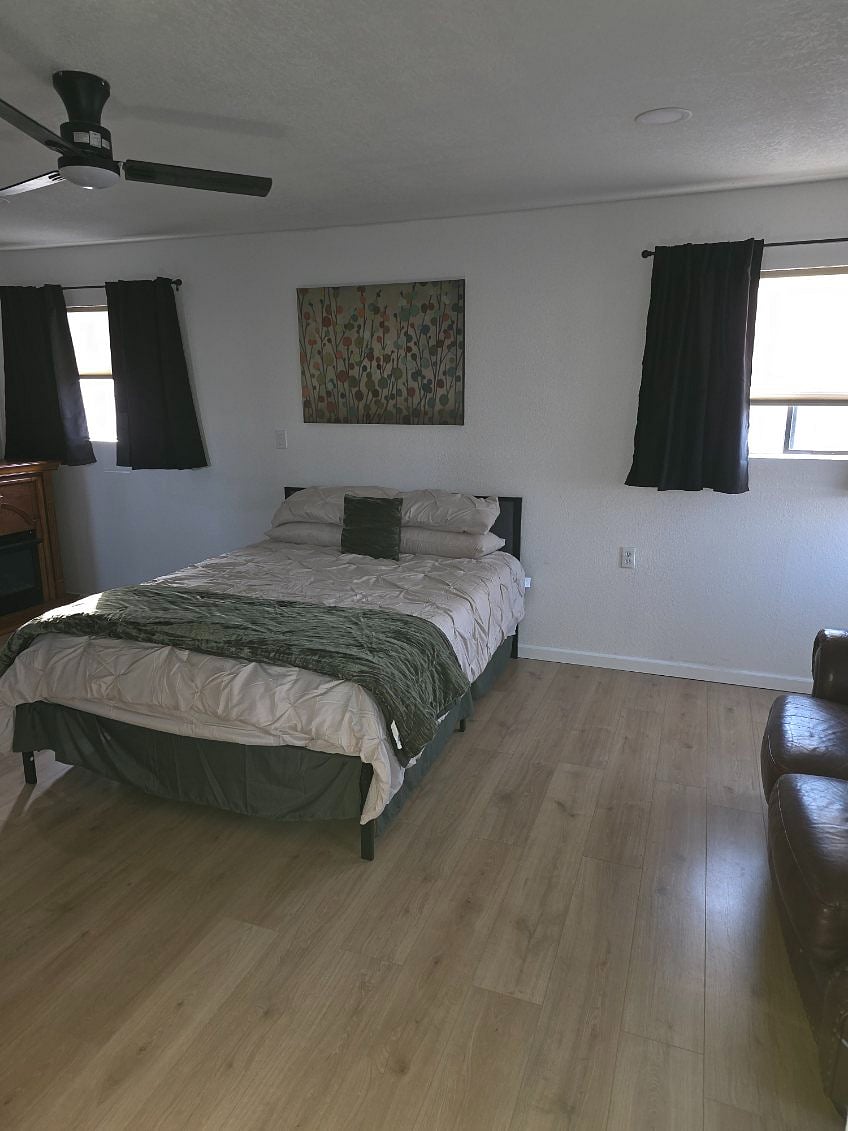 Master Suite, queen size bed,
Dual head walk in shower, his and her sink, cozy fireplace, remote ceiling fan, 65 inch TV, mini fridge, walk-in closet, and a nice couch for relaxing