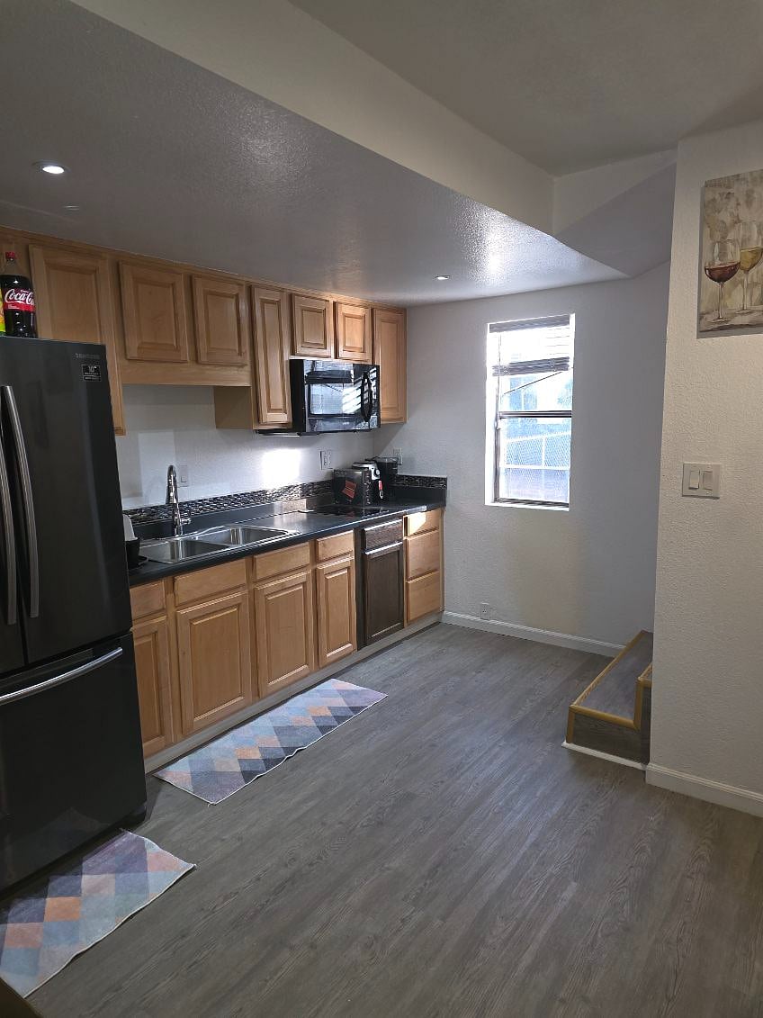 Welcome to our Guest House first level kitchenette, featuring, 2 burner glass electric top stove, full size refrigerator, microwave, dishes, pots and pans, Keurig coffee maker, air fryer basket.