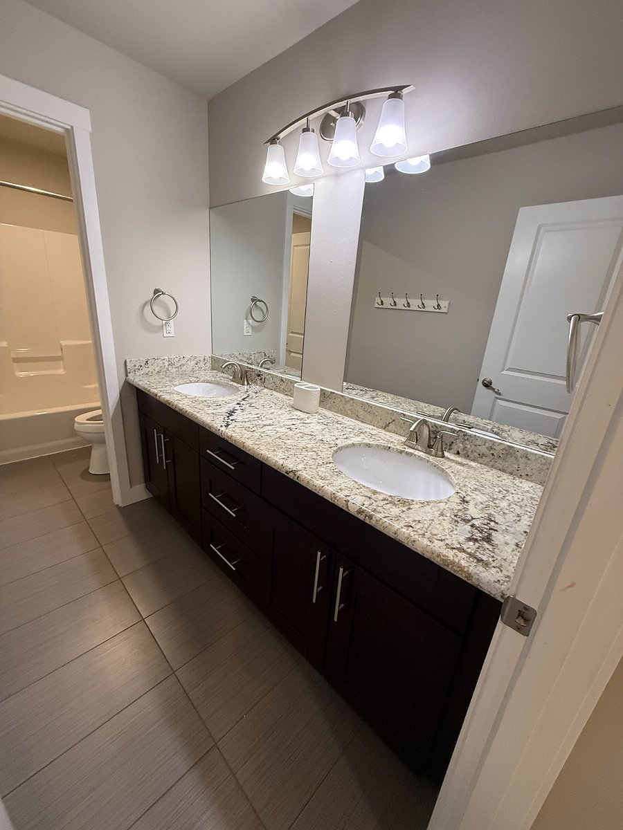 Upstairs shared bathroom double vanity.