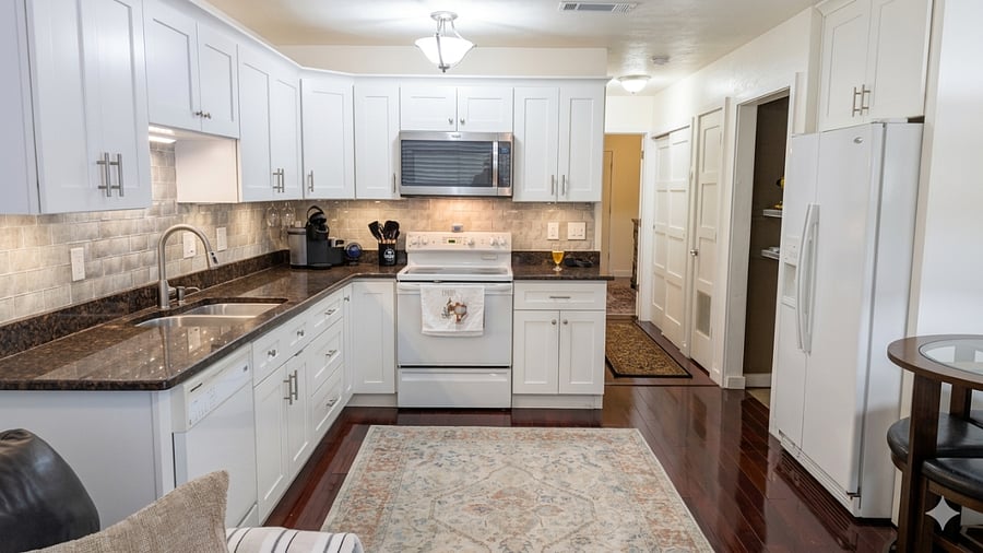 The kitchen was remodeled with glass subway tiles and marble countertops. All solid wood craftsman cabinets with above and below cabinet adjustable lights. Over twelve full size cabinets and 4 large deep pullout drawers.