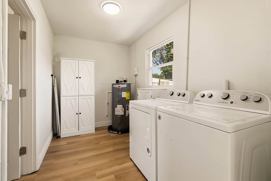 Everything you need for a comfortable stay: A spacious laundry area and a dedicated spot for your dry goods in our organized pantry cabinet.