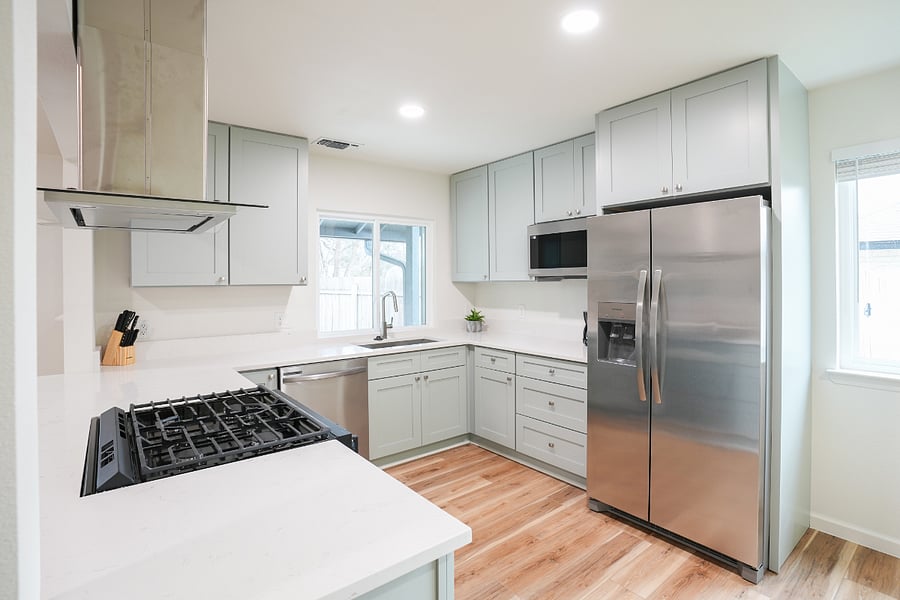 counter top modern gas stove, new appliances, large stainless steel sink with over the counter full size microwave and spacious cabinet system, fully stocked.