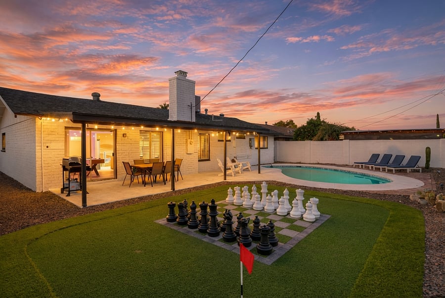 Private backyard retreat featuring a pool, covered dining patio, and outdoor lounge space