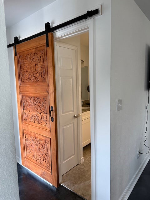 Carved door on the bathroom shared by both bedrooms