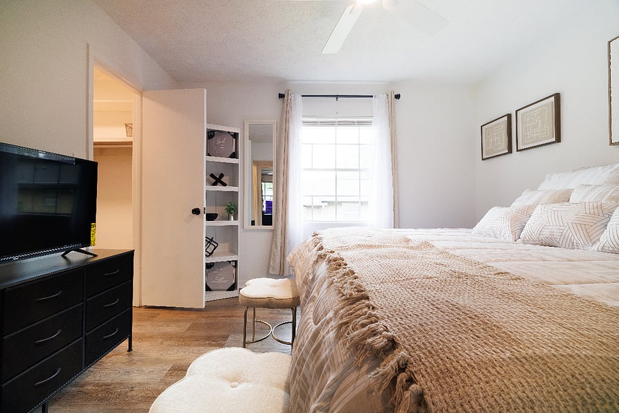 bedroom 2 set up as a king with view of smart tv, dresser and decor