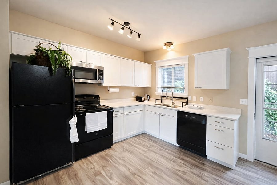 Fully equipped kitchen featuring All-Clad stainless steel pots and pans.