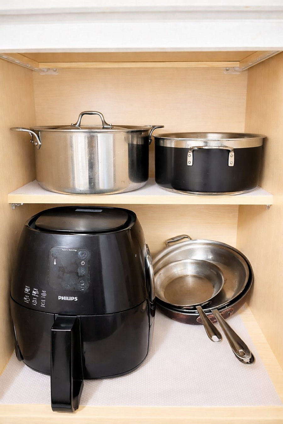 Fully equipped kitchen featuring All-Clad stainless steel pots and pans