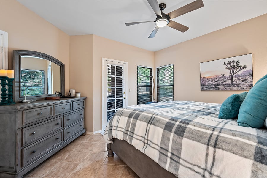 Primary bedroom with door to patio.