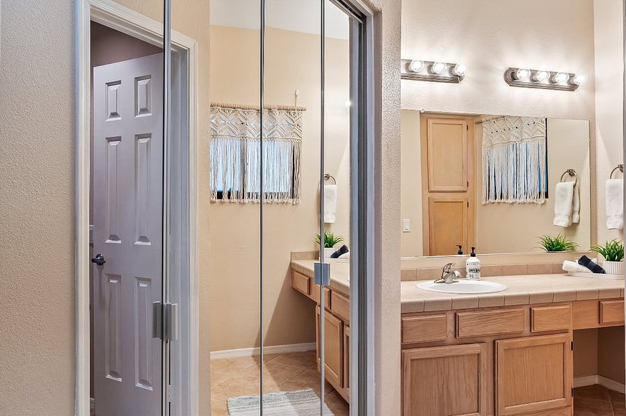 Primary bedroom has huge walk-in closet. Tennis and pickleball racquets and balls, blue tooth radio, pool floats, weight scale and more.