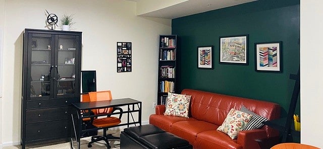Living room with showing workstation with comfy desk chair.