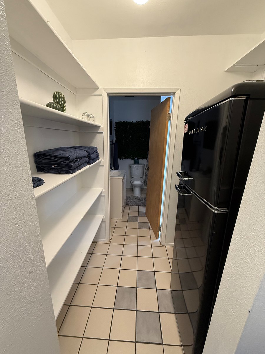 Pantry area, refrigerator, and lots of storage plus multiple cleaning supplies.