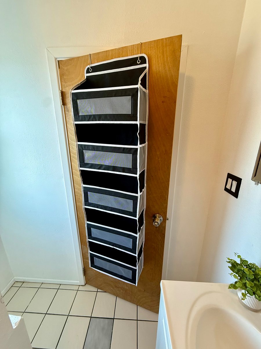 Additional storage hanging on the bathroom door.