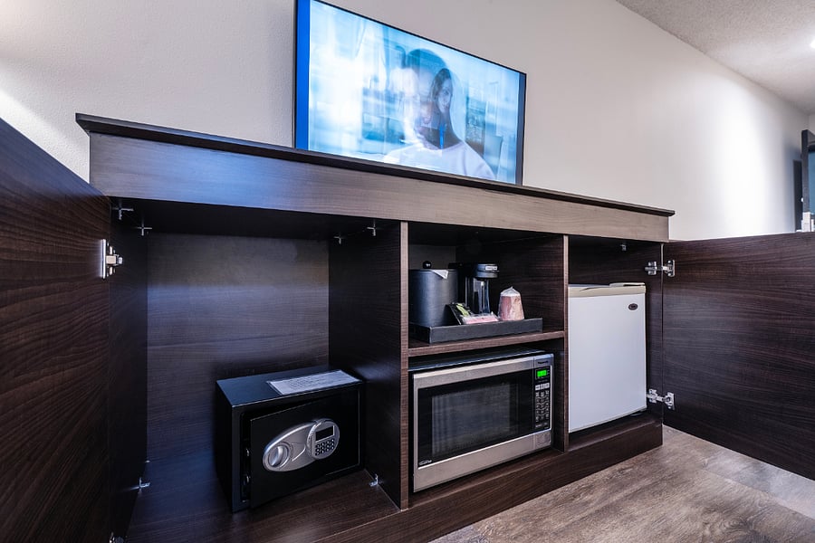Convenient in-room amenities including microwave, mini refrigerator, coffee station, and secure safe  perfect for comfortable extended stays
