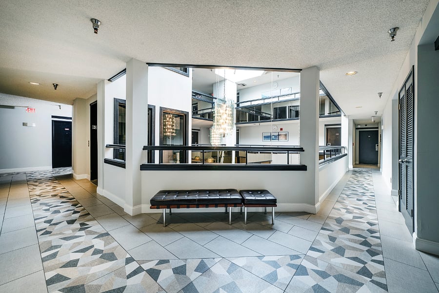 Interior corridor access with controlled entry  guests enter through the main entrance and front desk, supporting a safe and secure environment with 24/7 monitored security cameras.