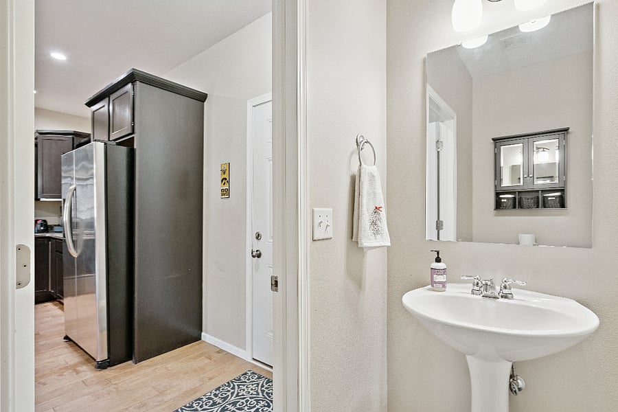 Powder room off kitchen and garage entrance
