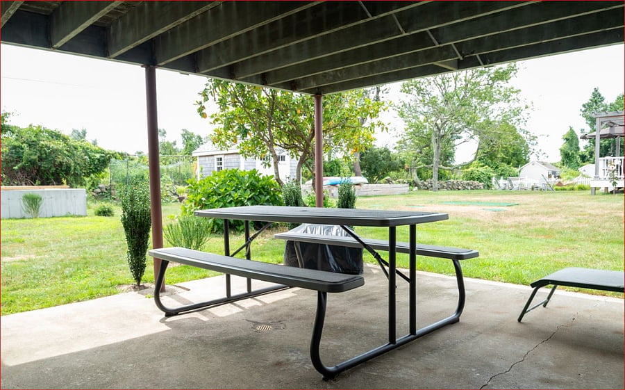 Large patio under rear deck accessible from garden level