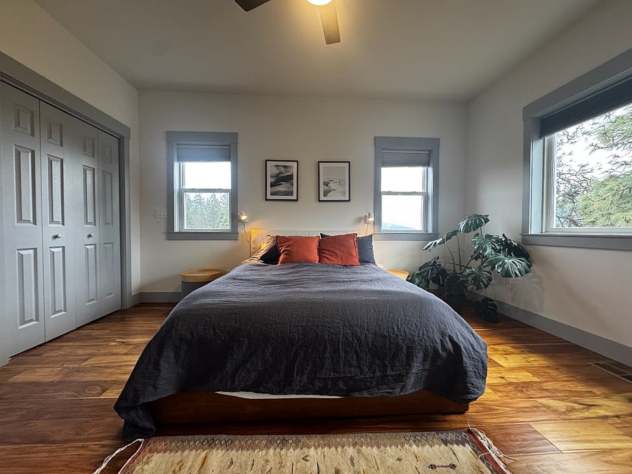 Primary bedroom with mountain views and relaxing linens