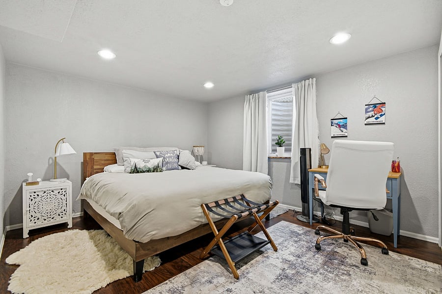 Comfortable king size bed in primary bedroom with desk area