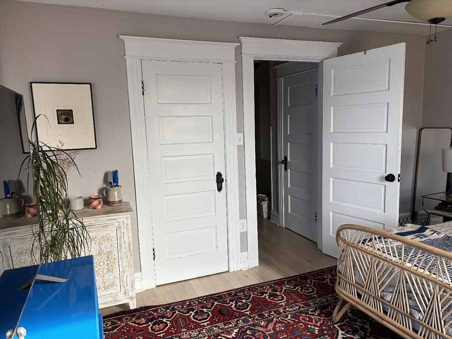 This view of the inside of the available bedroom shows closet door and the door to the bedroom.