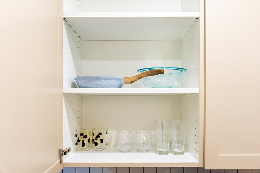 Kitchen cabinet with cookware and drinkware