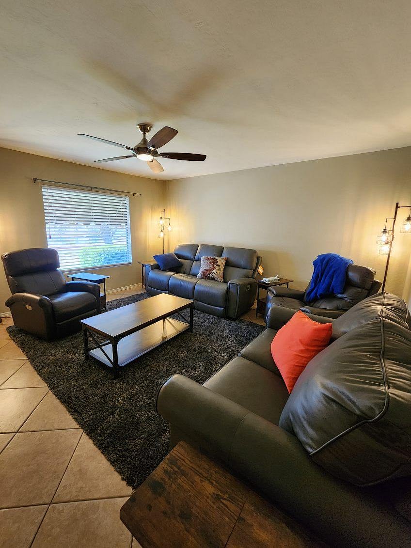 Lake-view living room with Laz-E-Boy recliner couches and large smart TV.