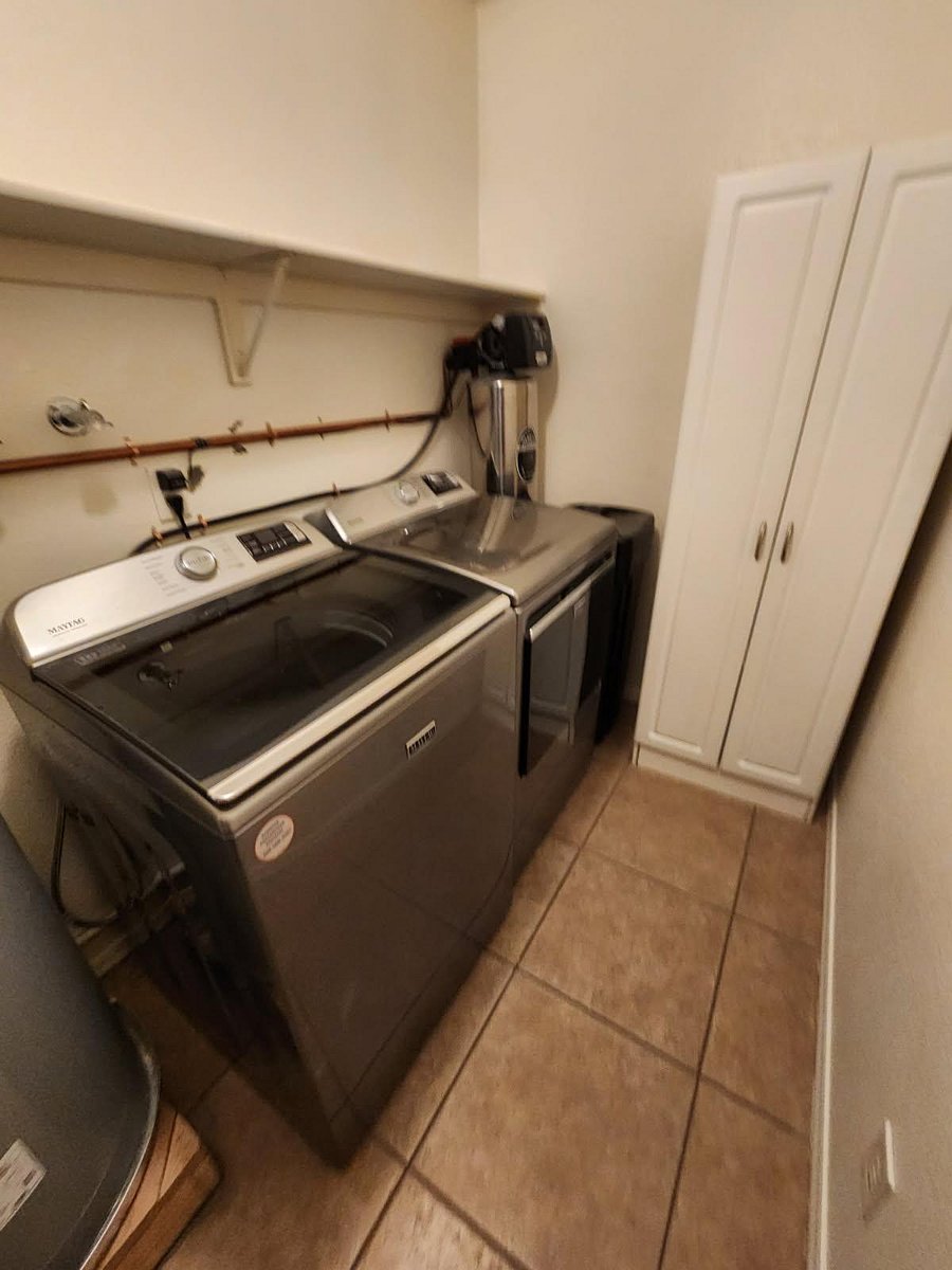 Inside laundry room has modern full size washer,dryer and whole home water softrener.