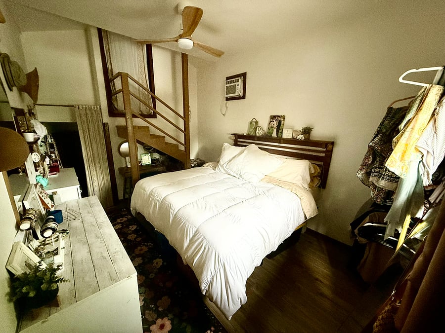 Master bedroom with high ceilings, clothing rack, dresser, vanity table, and private bath.
(upstairs loft is a partial storage)
